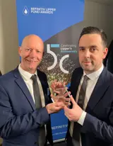 two men holding an award